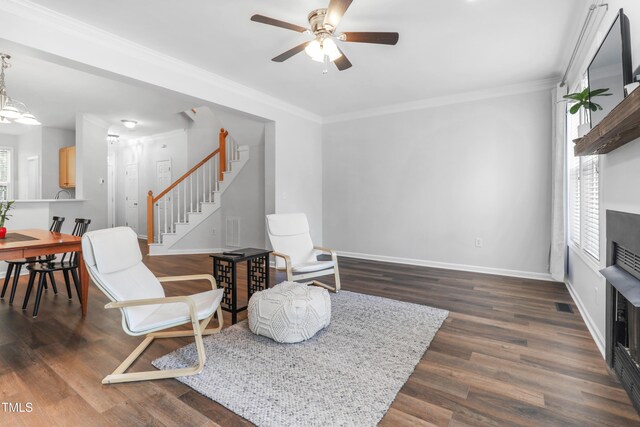 412 Heritage Village Ln, Apex, NC 27502 - sitting room featuring stairs, ceiling fan, a fireplace, baseboards, and dark wood-style floors