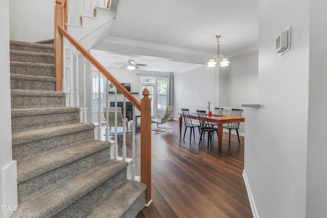 412 Heritage Village Ln, Apex, NC 27502 - staircase featuring ornamental molding, wood finished floors, a ceiling fan, baseboards, and a chandelier