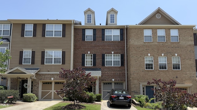 106 Gallent Hedge Trl, Apex, NC 27539 - townhome / multi-family property featuring a garage, brick siding, and driveway