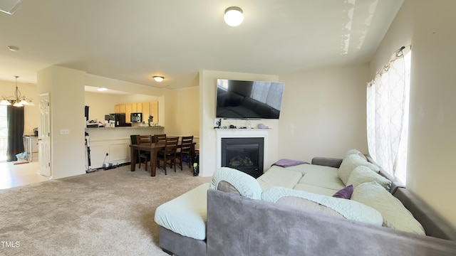 106 Gallent Hedge Trl, Apex, NC 27539 - living area with plenty of natural light, light carpet, a chandelier, and a glass covered fireplace
