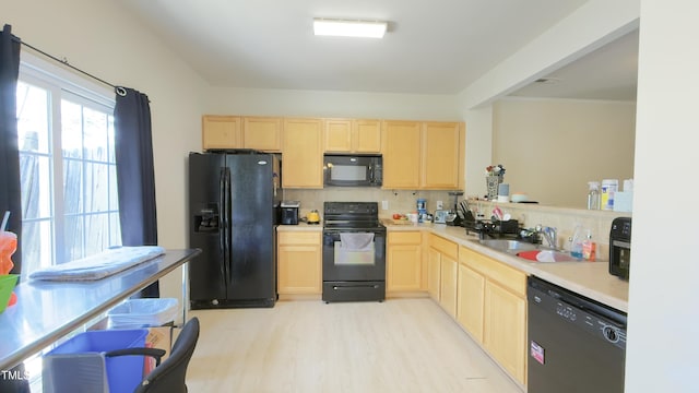 106 Gallent Hedge Trl, Apex, NC 27539 - kitchen featuring black appliances, light brown cabinets, a sink, and light wood-style flooring