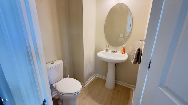 106 Gallent Hedge Trl, Apex, NC 27539 - bathroom with toilet, wood finished floors, baseboards, and a sink