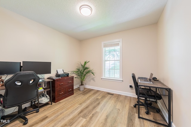 358 Tillamook Dr, Wake Forest, NC 27587 - home office with light wood-style flooring, baseboards, and a textured ceiling