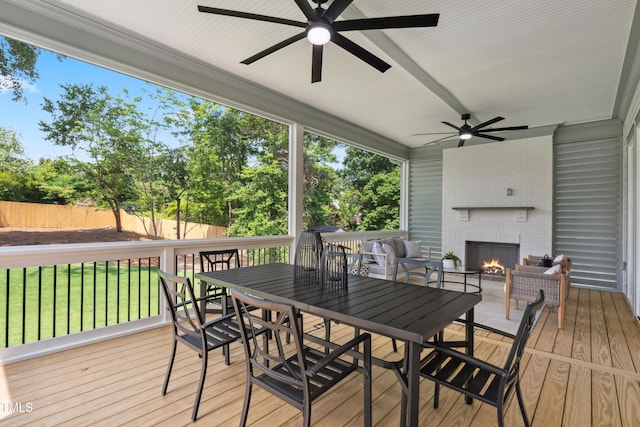 217 Dublin Rd, Raleigh, NC 27609 - wooden terrace with a fireplace, a ceiling fan, outdoor dining area, and view of wooded area