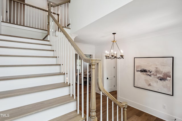 217 Dublin Rd, Raleigh, NC 27609 - staircase featuring wood finished floors, crown molding, a chandelier, and baseboards