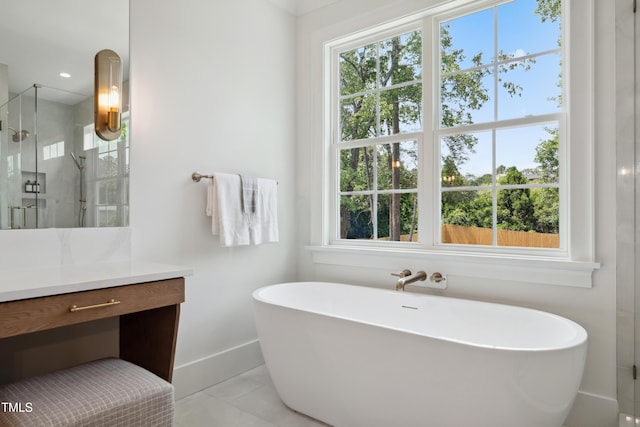 217 Dublin Rd, Raleigh, NC 27609 - full bathroom featuring vanity, a freestanding tub, a shower stall, and baseboards