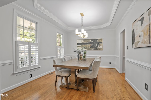 314 Chanticlair Dr, Apex, NC 27502 - dining area featuring a chandelier, light wood-style flooring, ornamental molding, baseboards, and a tray ceiling