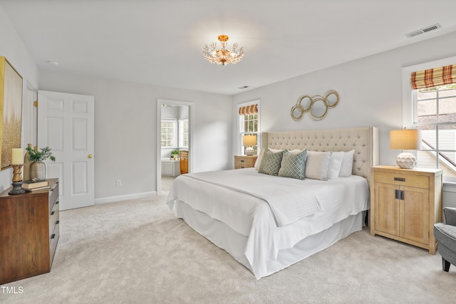 314 Chanticlair Dr, Apex, NC 27502 - bedroom with light carpet, multiple windows, baseboards, and a chandelier