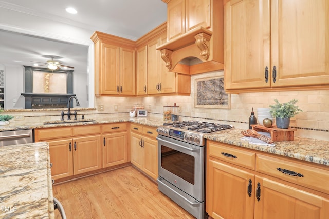 314 Chanticlair Dr, Apex, NC 27502 - kitchen with appliances with stainless steel finishes, light brown cabinetry, light wood finished floors, light stone countertops, and backsplash