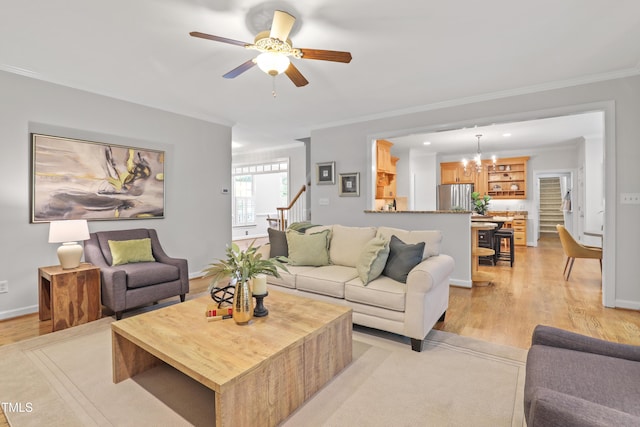314 Chanticlair Dr, Apex, NC 27502 - living room with a ceiling fan, ornamental molding, light wood-style flooring, a chandelier, and baseboards