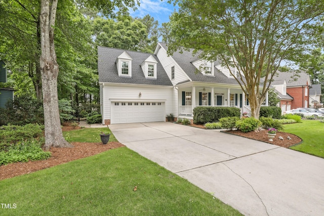 314 Chanticlair Dr, Apex, NC 27502 - new england style home featuring concrete driveway, a front yard, a porch, a garage, and roof with shingles