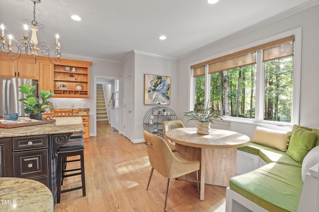 314 Chanticlair Dr, Apex, NC 27502 - dining space with stairs, ornamental molding, light wood-style floors, a chandelier, and recessed lighting
