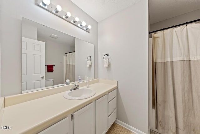 72 Justin Ct, Durham, NC 27705 - full bathroom featuring vanity, a shower with curtain, baseboards, toilet, and a textured ceiling
