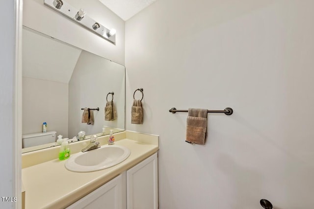 72 Justin Ct, Durham, NC 27705 - bathroom featuring vanity, lofted ceiling, and toilet