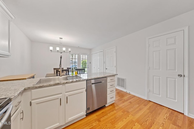 72 Justin Ct, Durham, NC 27705 - kitchen with stainless steel appliances, a sink, light wood-type flooring, and white cabinets
