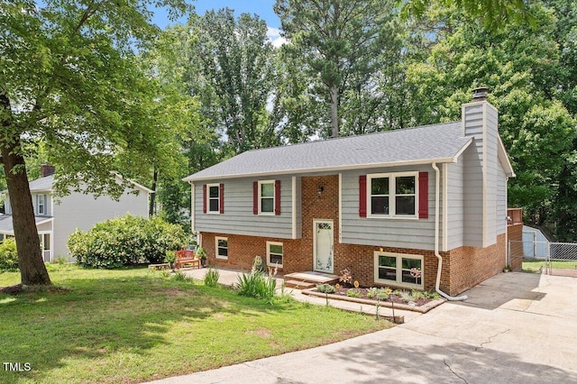 105 Otter Dr, Cary, NC 27513 - bi-level home with a chimney, brick siding, driveway, and a gate