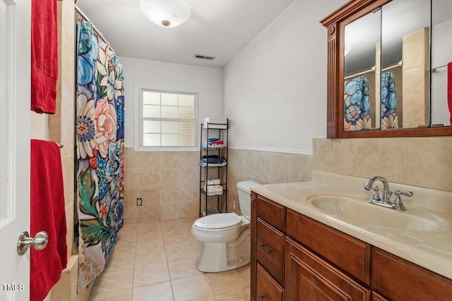 105 Otter Dr, Cary, NC 27513 - full bathroom with vanity, tile patterned floors, tile walls, and a wainscoted wall