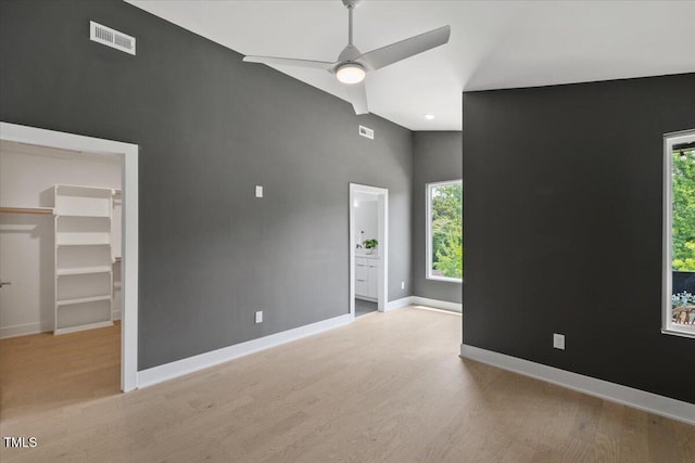 2225 Millbank Village Ct Unit 101, Raleigh, NC 27610 - empty room with light wood-style flooring, baseboards, ceiling fan, healthy amount of natural light, and a high ceiling