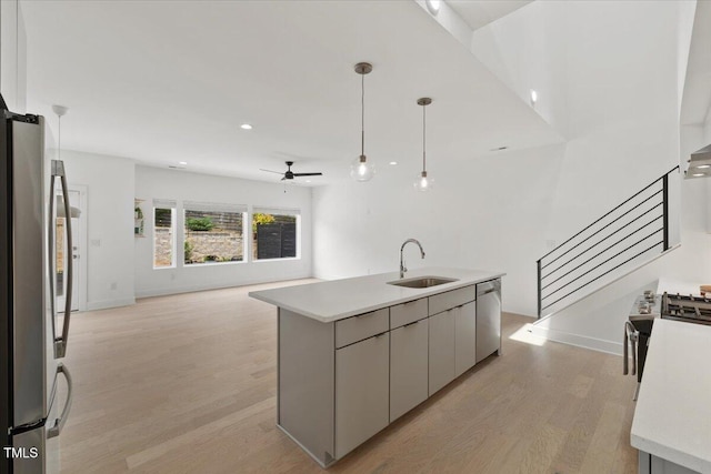 2225 Millbank Village Ct Unit 101, Raleigh, NC 27610 - kitchen with a sink, dishwasher, light wood-style floors, open floor plan, and light countertops