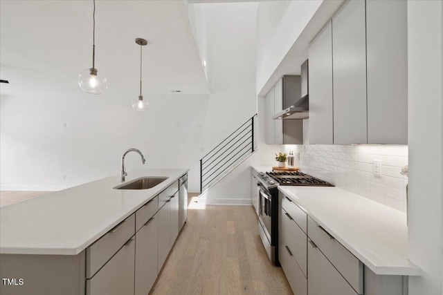 2225 Millbank Village Ct Unit 101, Raleigh, NC 27610 - kitchen with appliances with stainless steel finishes, a sink, light wood-style flooring, backsplash, and baseboards