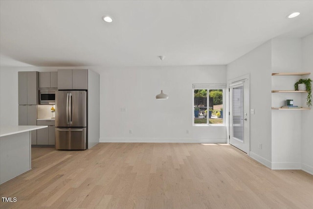 2225 Millbank Village Ct Unit 101, Raleigh, NC 27610 - unfurnished living room with light wood-style flooring, baseboards, and recessed lighting