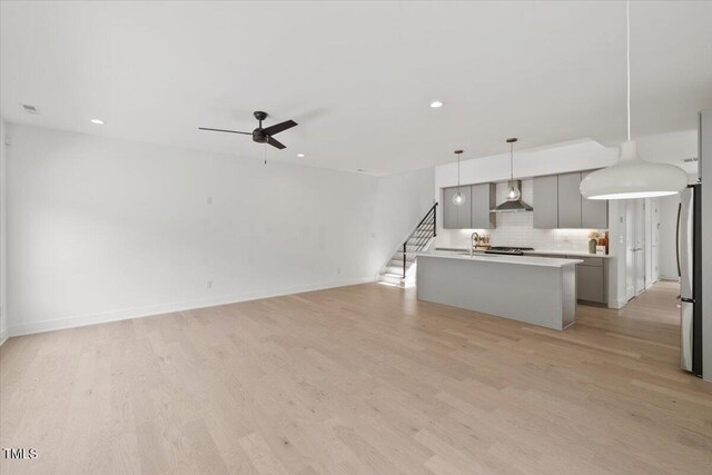 2225 Millbank Village Ct Unit 101, Raleigh, NC 27610 - unfurnished living room featuring ceiling fan, a sink, light wood-style floors, recessed lighting, and baseboards