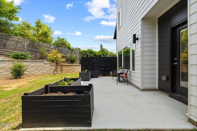 2225 Millbank Village Ct Unit 101, Raleigh, NC 27610 - fenced backyard featuring a vegetable garden and a patio area