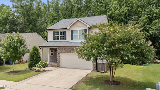 205 Willow Weald Ct, Fuquay Varina, NC 27526 - view of front of property featuring a garage, concrete driveway, stone siding, and a front yard