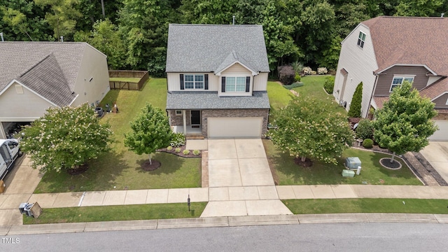 205 Willow Weald Ct, Fuquay Varina, NC 27526 - view of front of house featuring driveway, roof with shingles, an attached garage, brick siding, and a front yard