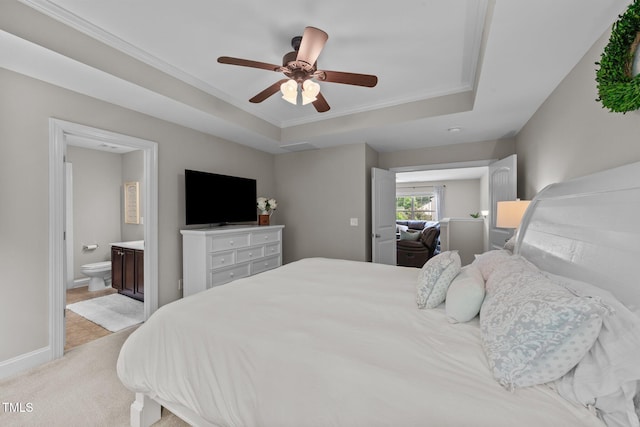 205 Willow Weald Ct, Fuquay Varina, NC 27526 - bedroom featuring a tray ceiling, ornamental molding, light colored carpet, baseboards, and ensuite bathroom