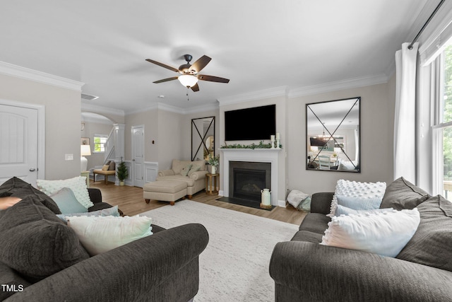 205 Willow Weald Ct, Fuquay Varina, NC 27526 - living room featuring arched walkways, a ceiling fan, wood finished floors, plenty of natural light, and ornamental molding