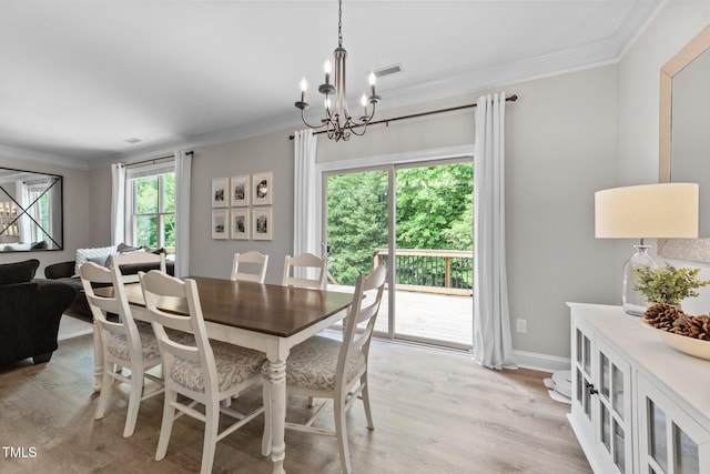 205 Willow Weald Ct, Fuquay Varina, NC 27526 - dining space with a chandelier, light wood finished floors, crown molding, and baseboards
