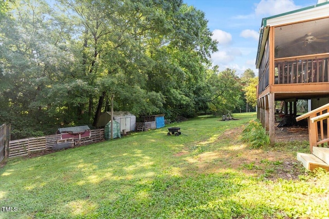 3298 Oakridge Dr Unit A, Graham, NC 27253 - view of green lawn featuring a sunroom, an outdoor fire pit, and view of scattered trees