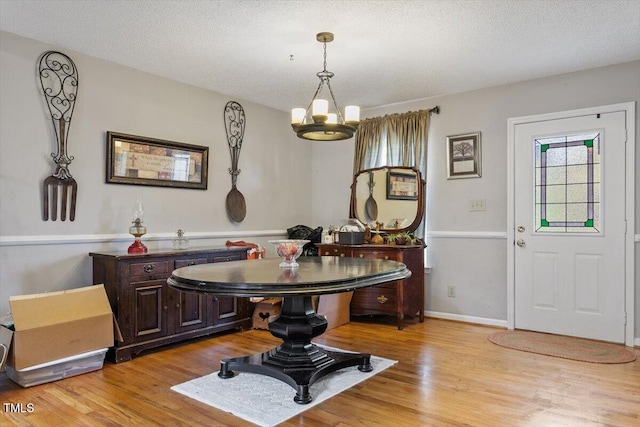 3298 Oakridge Dr Unit A, Graham, NC 27253 - foyer with a chandelier, light wood-style floors, a textured ceiling, and baseboards