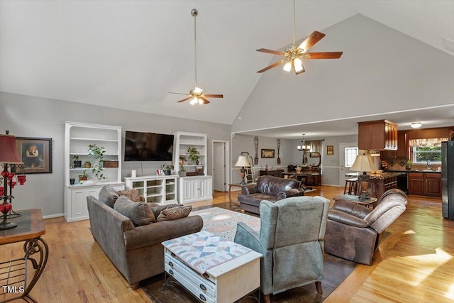3298 Oakridge Dr Unit A, Graham, NC 27253 - living room with light wood-style flooring, a ceiling fan, high vaulted ceiling, a chandelier, and built in features