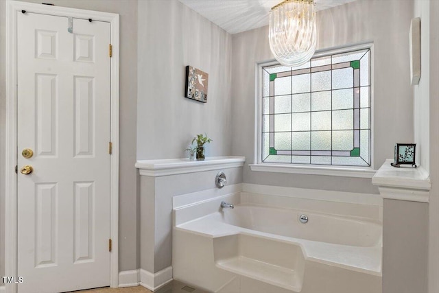 3298 Oakridge Dr Unit A, Graham, NC 27253 - full bathroom featuring a bath, a chandelier, and baseboards