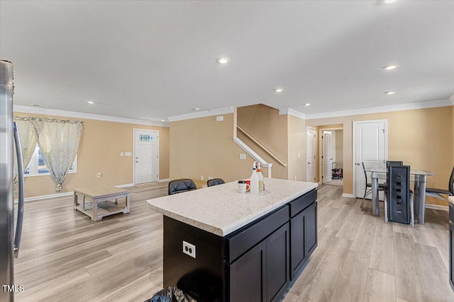 1004 Bridgewater Dr, Durham, NC 27704 - kitchen with light wood finished floors, a center island, recessed lighting, light countertops, and baseboards