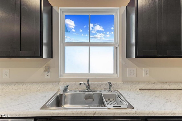 1004 Bridgewater Dr, Durham, NC 27704 - kitchen with a sink, dark cabinets, and plenty of natural light