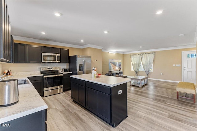 1004 Bridgewater Dr, Durham, NC 27704 - kitchen featuring stainless steel appliances, a sink, light countertops, a kitchen island, and ornamental molding