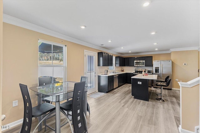 1004 Bridgewater Dr, Durham, NC 27704 - dining space with baseboards, light wood-type flooring, ornamental molding, and recessed lighting