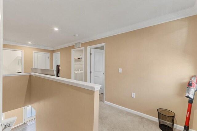 1004 Bridgewater Dr, Durham, NC 27704 - hallway featuring crown molding, baseboards, recessed lighting, washer / clothes dryer, and light carpet