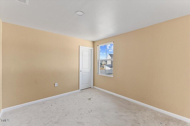 1004 Bridgewater Dr, Durham, NC 27704 - spare room featuring baseboards and light carpet