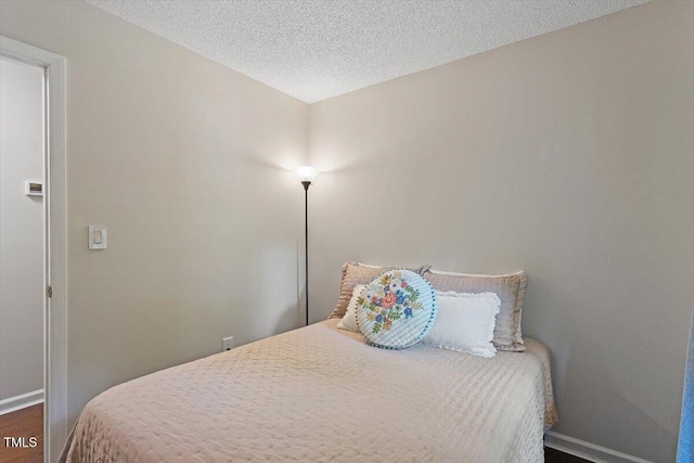 1 Old Towne Pl, Durham, NC 27713 - bedroom featuring baseboards, wood finished floors, and a textured ceiling