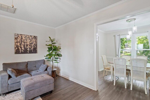 1 Old Towne Pl, Durham, NC 27713 - living room featuring wood finished floors, a textured ceiling, crown molding, and baseboards