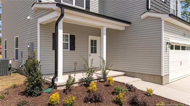 60 Bennett Rd, Coats, NC 27521 - view of side of home with central AC unit, a garage, and a porch