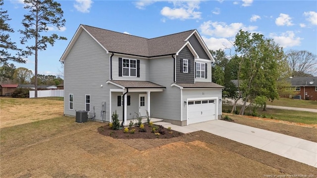 60 Bennett Rd, Coats, NC 27521 - view of front of house with driveway, an attached garage, a front yard, central AC unit, and a shingled roof