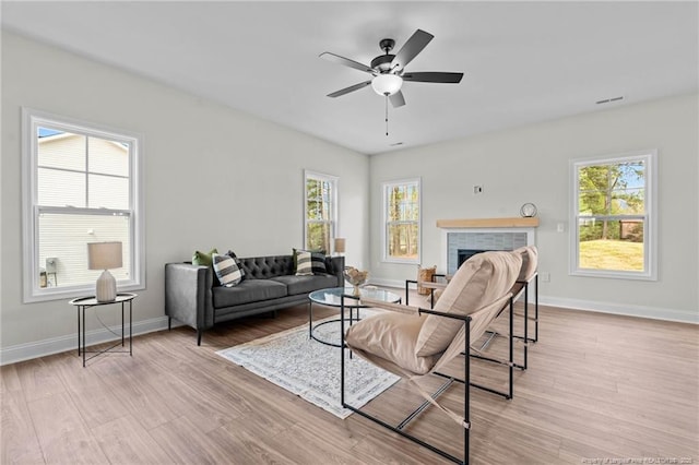 60 Bennett Rd, Coats, NC 27521 - living room featuring wood finished floors, plenty of natural light, a brick fireplace, and a ceiling fan
