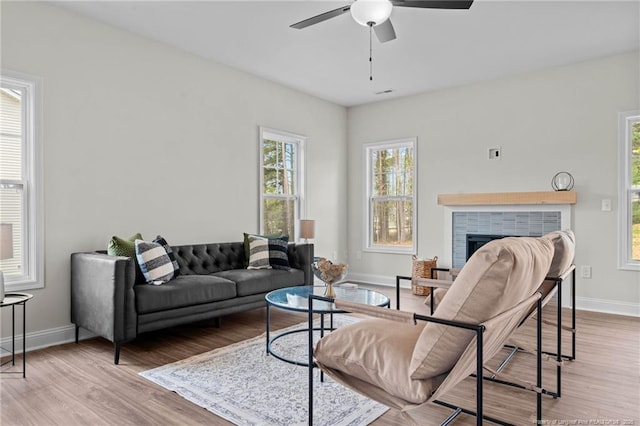 60 Bennett Rd, Coats, NC 27521 - living room with a ceiling fan, a fireplace, baseboards, and wood finished floors