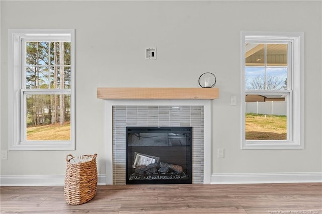 60 Bennett Rd, Coats, NC 27521 - detailed view of a tiled fireplace, baseboards, and wood finished floors