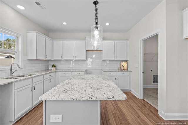 60 Bennett Rd, Coats, NC 27521 - kitchen with a sink, white cabinets, wood finished floors, and recessed lighting